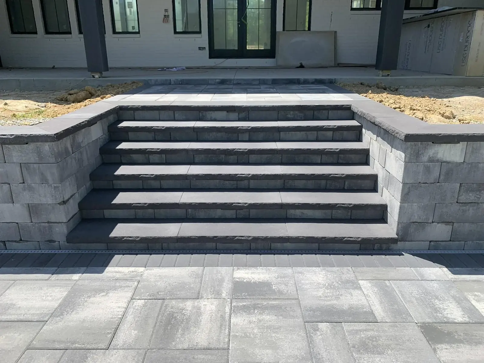 Illuminated paver patio steps at a new construction home