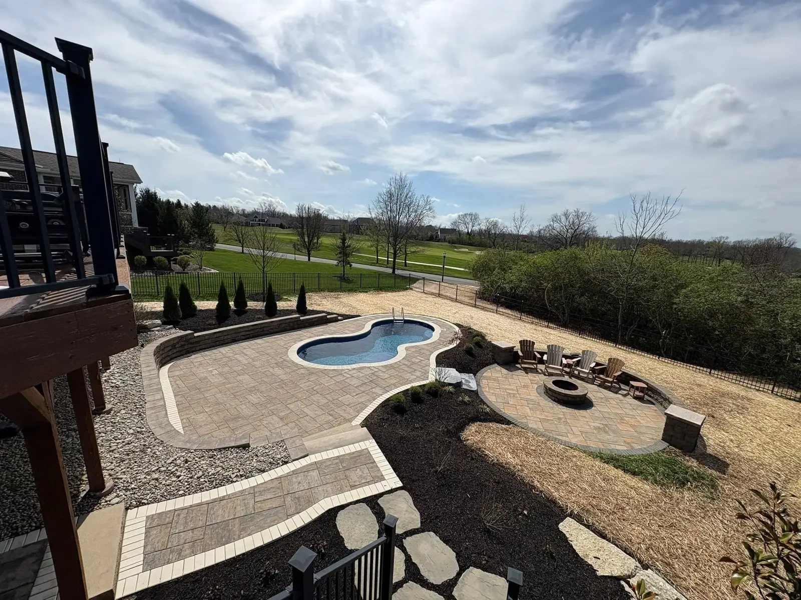 Backyard fire pit seating area with golf course view