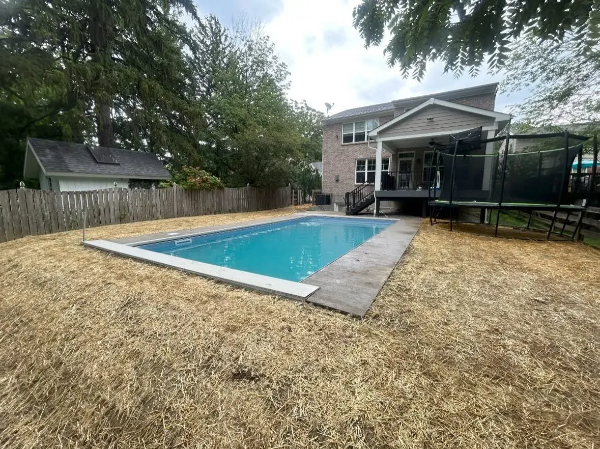 New paver patio and pool deck with fresh landscaping